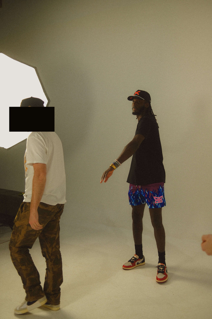 Translation missing: en.Two people standing in a studio setting with neutral background