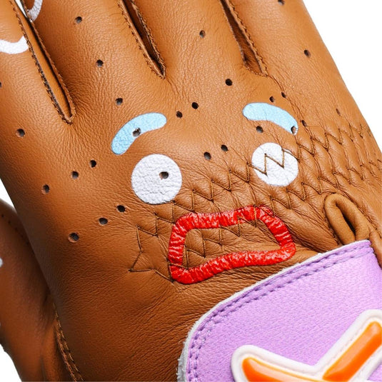 Closeup of the Gingerbread Man Golf Glove Gingy face across the knuckles with blue frosting eyebrows, white frosting eyes, and red frosting mouth in a worried facial expression.