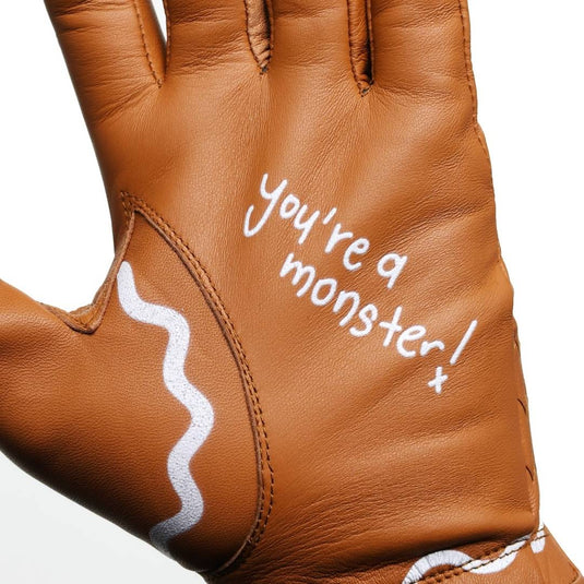 You're a monster written across the palm of the Gingerbread Man Golf Glove in white frosting style print.