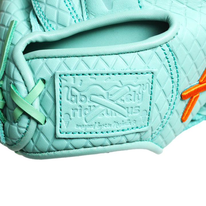 Translation missing: en.close up of the absolutely ridiculous patch on the all mint youth catchers mitt with the orange "X" logo near the thumb on the right side of the glove