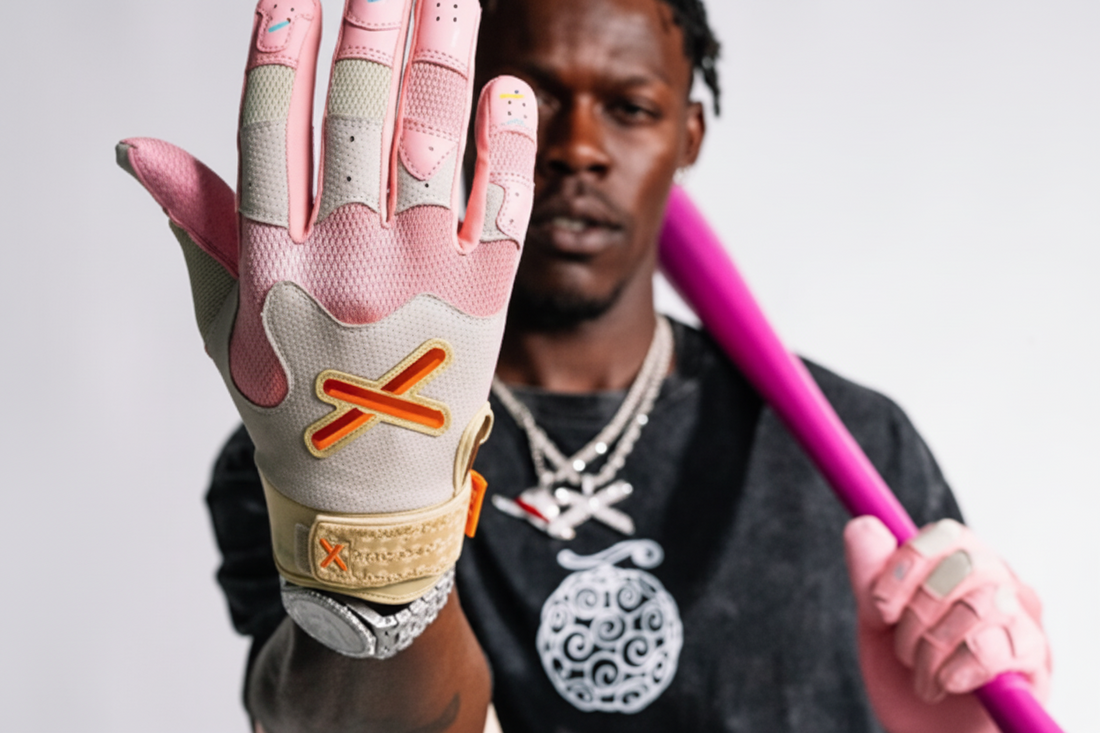 Person wearing a pink and gray glove with an 'X' logo, holding a pink bat against a gray background