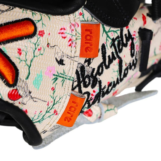 Zoomed-in detail of the glove’s floral design and orange rare tabs near the thumb area.