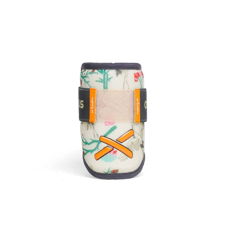 “Front view of a floral patterned elbow guard with orange X stitching and adjustable straps.”