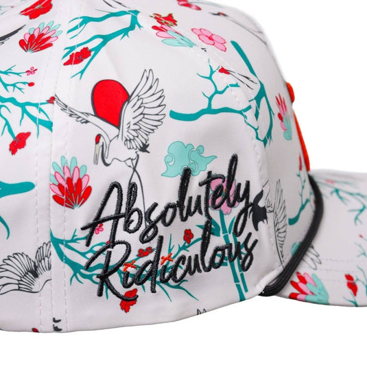 “side of the cap with ‘Absolutely Ridiculous’ embroidered text over a floral crane design.”