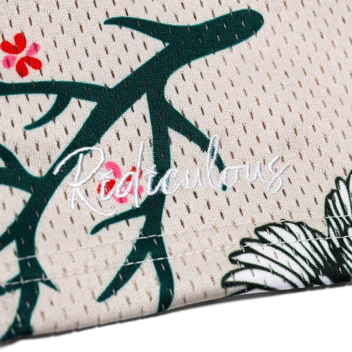 Translation missing: en.Close-up of a fabric with floral patterns and the brand name 'Ridiculous' embroidered