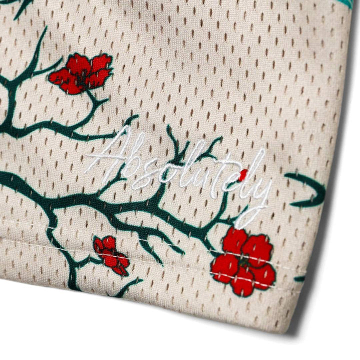 Translation missing: en.embroidery of the word 'absolutely' with red flowers and green branches behind the embroidery