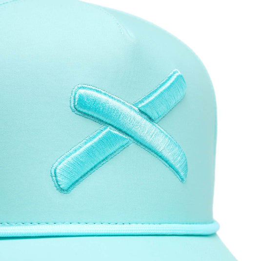 close up of mint dipped hat of the 'X' logo