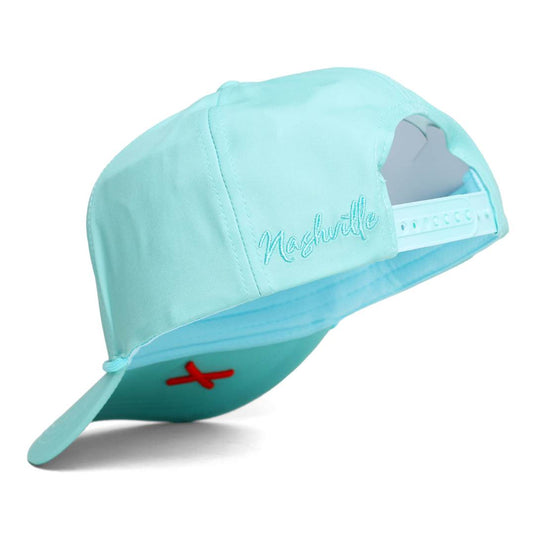 Mint colored hat with 'Nashville' text and orange 'X' logo below the bill