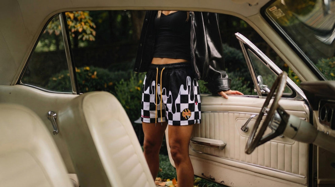 woman wearing rockstar shorts standing next to an open car door