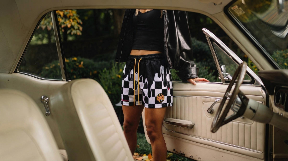 woman wearing rockstar shorts standing next to an open car door
