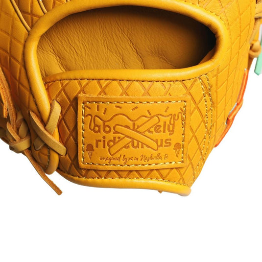 Close-up of a yellow / tan glove with the brand patch  